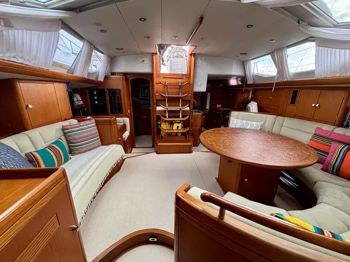  Yacht Photos Pics Luxurious interior of 2003 Oyster 56 yacht with elegant wood finish and cozy seating.