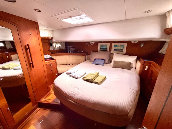  Yacht Photos Pics Luxurious cabin interior of 2003 Oyster 56 yacht with cozy bed and wooden furnishings.