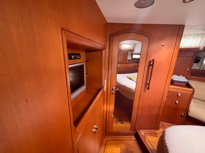  Yacht Photos Pics Interior of 2003 Oyster 56 yacht with wooden cabinetry and mirror door.