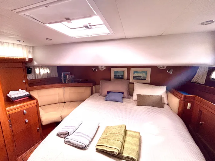 Yacht Photos Pics Luxurious cabin interior of a 2003 Oyster 56 yacht with cozy bedding and elegant decor.