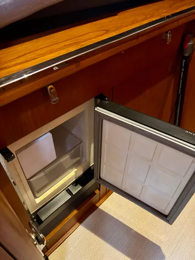  Yacht Photos Pics Open refrigerator in 2003 Oyster 56 yacht, showcasing interior storage space.