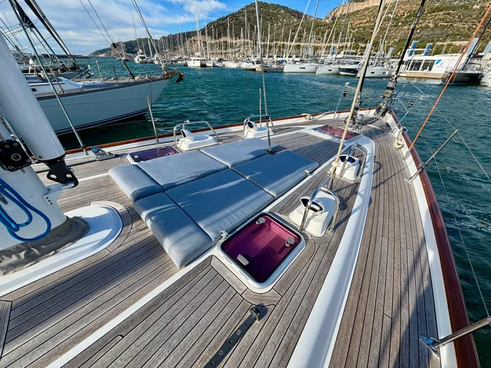  Yacht Photos Pics Deck of 2003 Oyster 56 yacht in marina, featuring sun loungers and scenic backdrop.