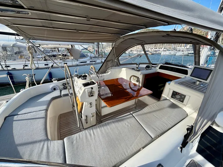  Yacht Photos Pics 2003 Oyster 56 yacht cockpit with cushioned seating and navigation equipment.