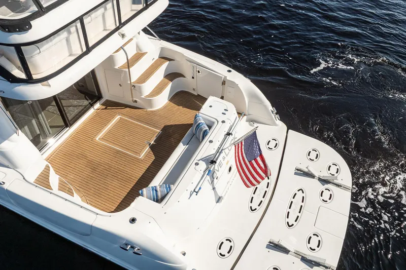 Love & Luck II Yacht Photos Pics 2007 Sea Ray 580 Sedan Bridge yacht with teak deck and American flag on water.
