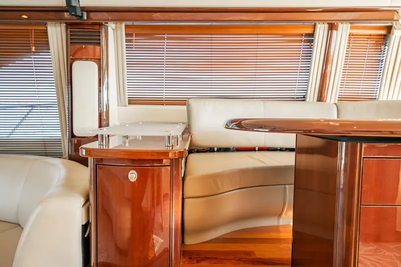 Love & Luck II Yacht Photos Pics Luxurious interior of 2007 Sea Ray 580 Sedan Bridge yacht with elegant wood finishes.