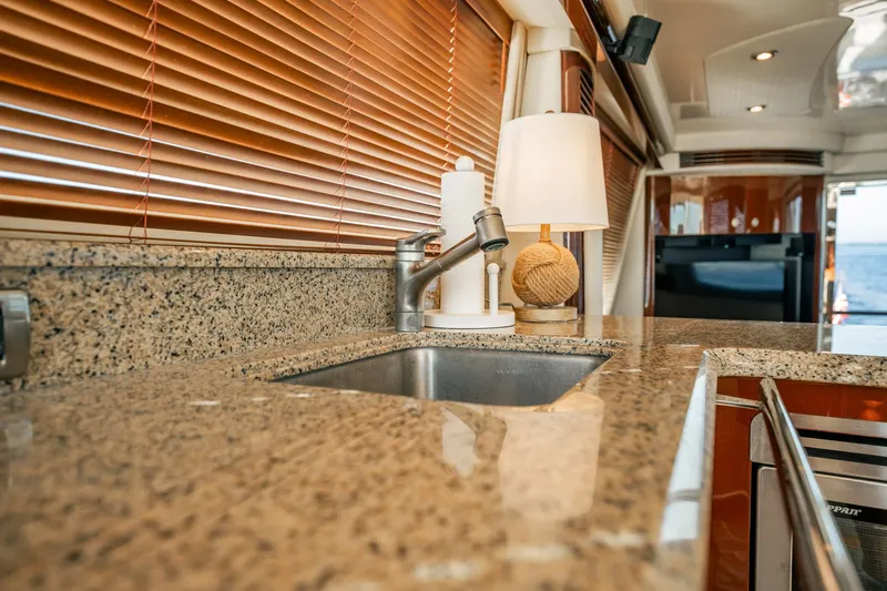 Love & Luck II Yacht Photos Pics Luxurious kitchen interior of 2007 Sea Ray 580 Sedan Bridge yacht with granite countertops.