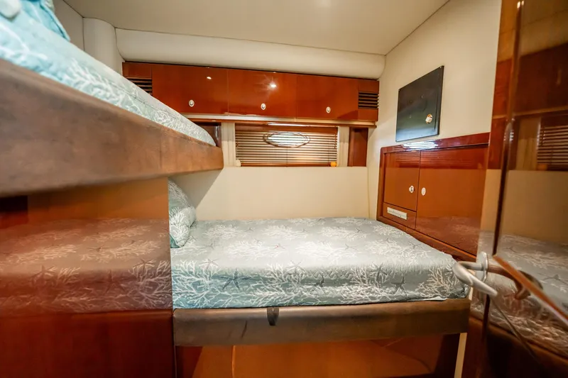 Love & Luck II Yacht Photos Pics Interior cabin of 2007 Sea Ray 580 Sedan Bridge with bunk beds and wooden cabinetry.