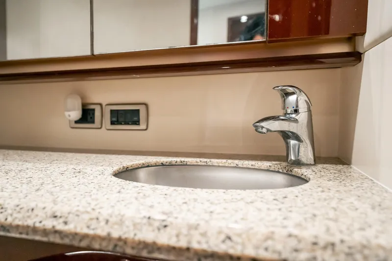 Love & Luck II Yacht Photos Pics Granite countertop with sink and faucet in 2007 Sea Ray 580 Sedan Bridge yacht bathroom.