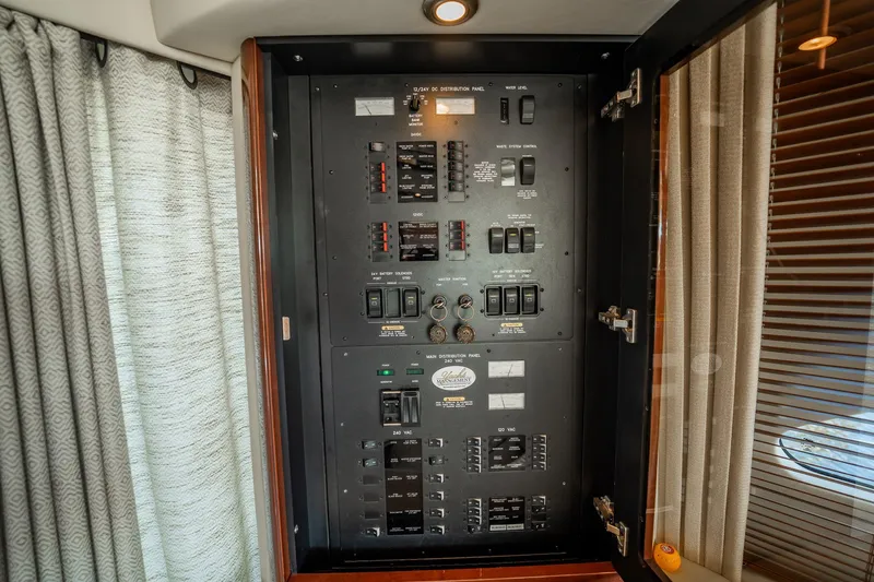 Love & Luck II Yacht Photos Pics Electrical panel inside 2007 Sea Ray 580 Sedan Bridge yacht, featuring switches and controls.