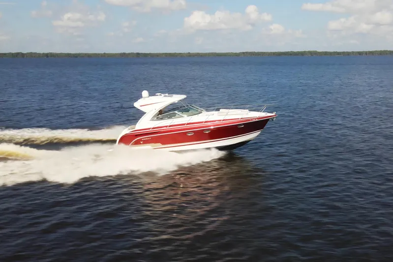 Let Me Liv! Yacht Photos Pics 2015 Formula 34 Performance Cruiser speeding on open water under a clear sky.