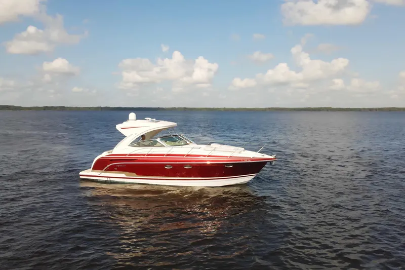 Let Me Liv! Yacht Photos Pics 2015 Formula 34 Performance Cruiser on calm water under a partly cloudy sky.