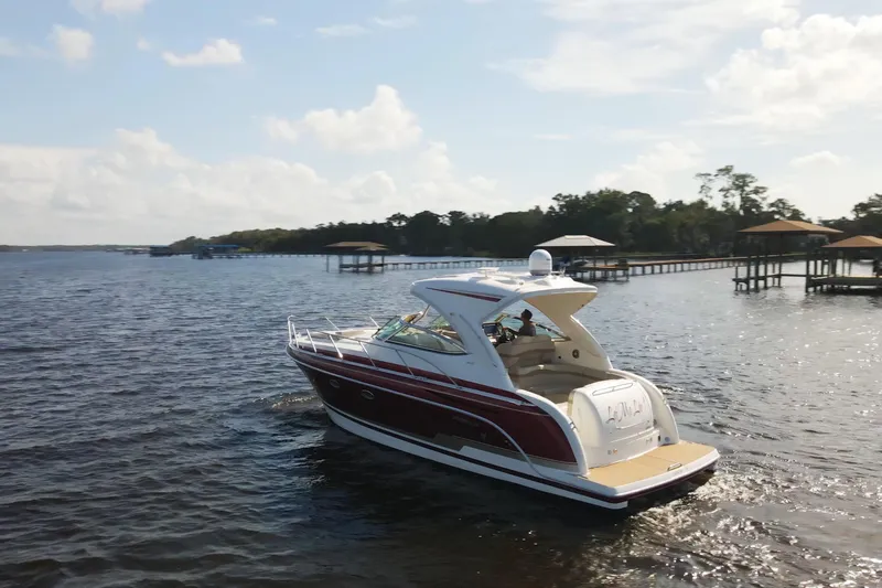 Let Me Liv! Yacht Photos Pics 2015 Formula 34 Performance Cruiser on a serene lake under a clear sky.
