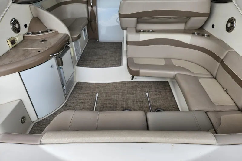 Let Me Liv! Yacht Photos Pics 2015 Formula 34 Performance Cruiser interior with beige seating and compact kitchenette.