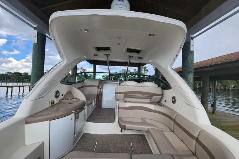 Let Me Liv! Yacht Photos Pics 2015 Formula 34 Performance Cruiser interior with seating and cabinetry, docked by a scenic waterfront.