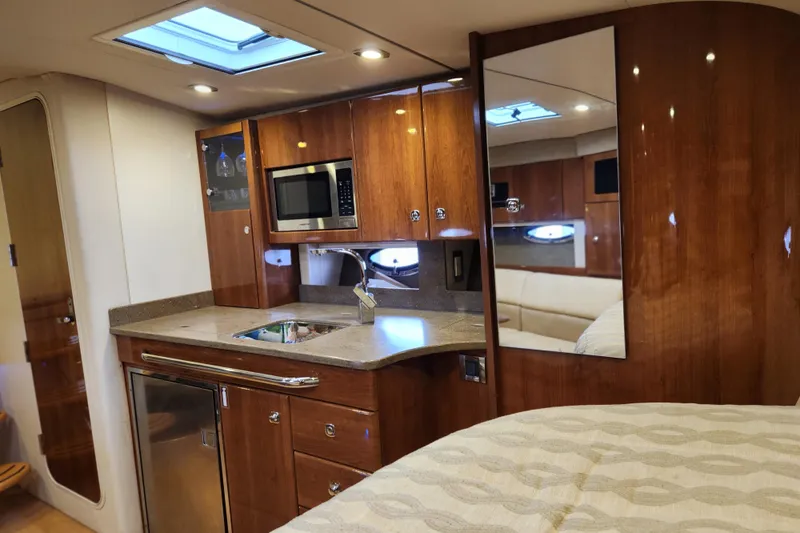 Let Me Liv! Yacht Photos Pics Luxurious interior of 2015 Formula 34 Performance Cruiser with kitchenette and wood finish.