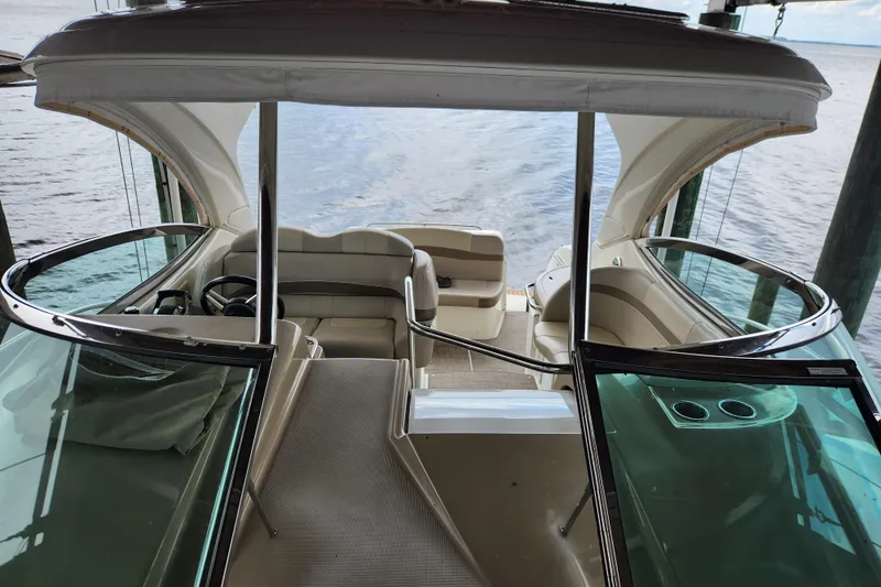Let Me Liv! Yacht Photos Pics 2015 Formula 34 Performance Cruiser interior with helm and seating, docked by the water.