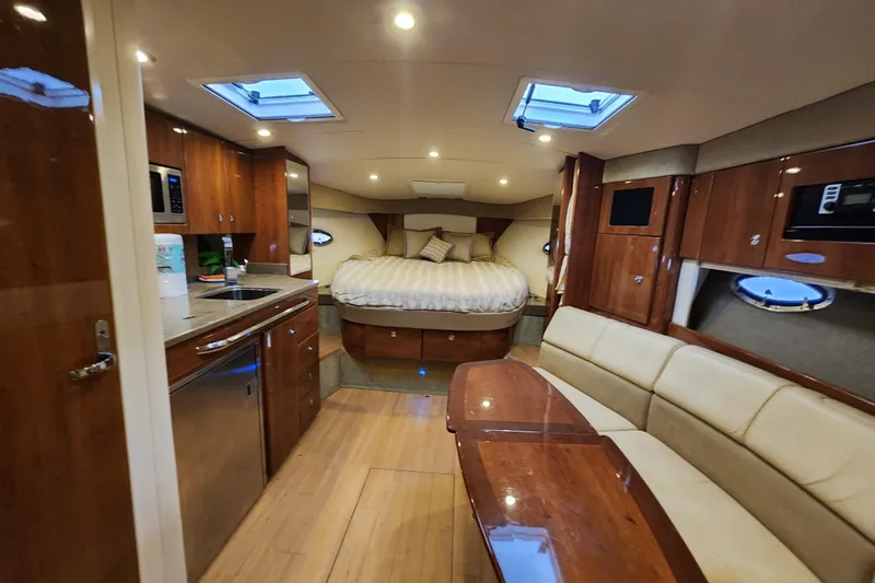 Let Me Liv! Yacht Photos Pics Luxurious interior of 2015 Formula 34 Performance Cruiser with kitchen, seating, and bed.