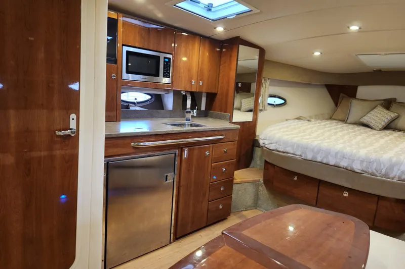 Let Me Liv! Yacht Photos Pics 2015 Formula 34 Performance Cruiser interior with kitchenette and cozy sleeping area.