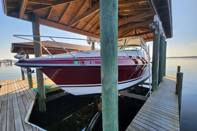 Let Me Liv! Yacht Photos Pics 2015 Formula 34 Performance Cruiser docked under wooden shelter by the water.