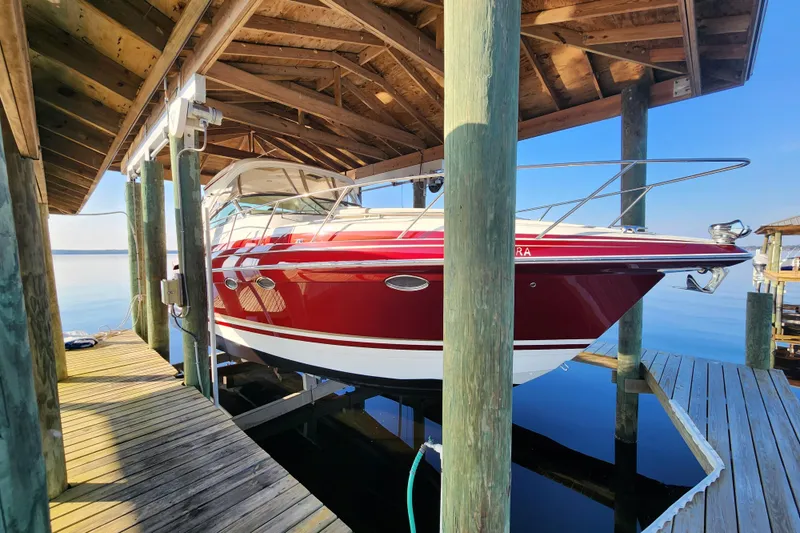 Let Me Liv! Yacht Photos Pics 2015 Formula 34 Performance Cruiser docked under wooden shelter.