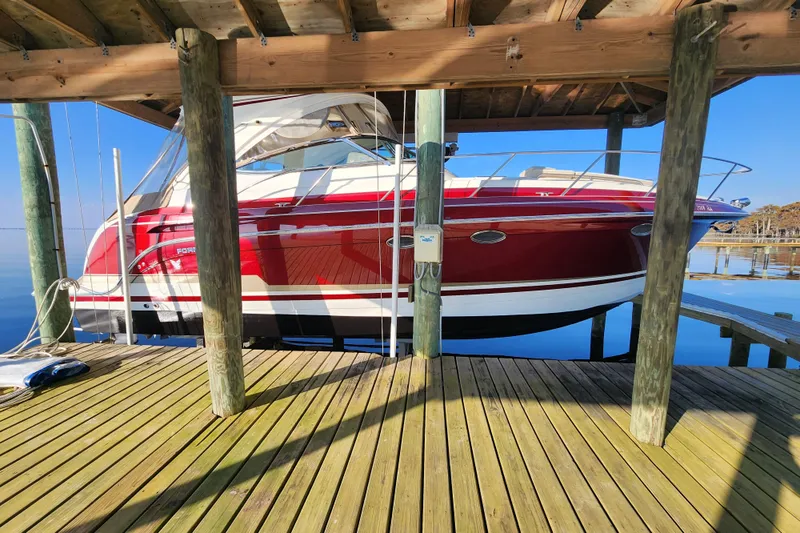 Let Me Liv! Yacht Photos Pics 2015 Formula 34 Performance Cruiser docked under wooden shelter.