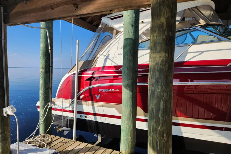 Let Me Liv! Yacht Photos Pics 2015 Formula 34 Performance Cruiser docked, featuring sleek red and white design.