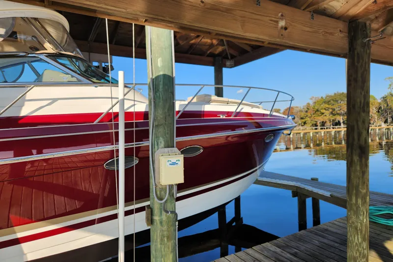 Let Me Liv! Yacht Photos Pics 2015 Formula 34 Performance Cruiser docked under wooden shelter by the water.