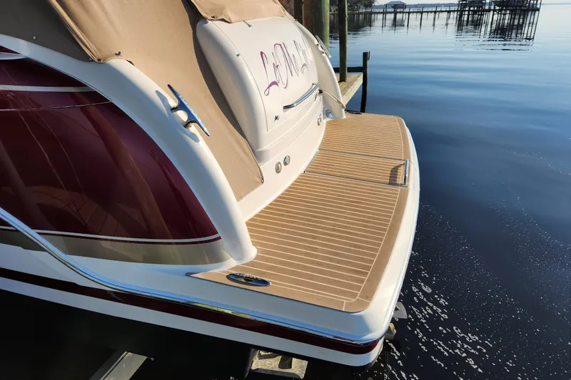 Let Me Liv! Yacht Photos Pics 2015 Formula 34 Performance Cruiser docked on calm water, rear view.