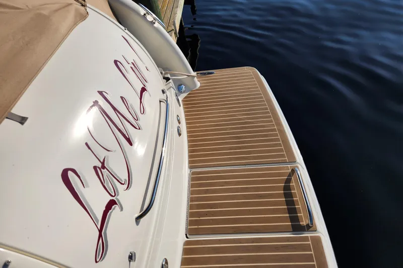 Let Me Liv! Yacht Photos Pics 2015 Formula 34 Performance Cruiser with teak deck, docked by calm water.