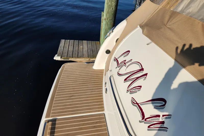 Let Me Liv! Yacht Photos Pics 2015 Formula 34 Performance Cruiser docked, featuring elegant lettering and wooden deck.