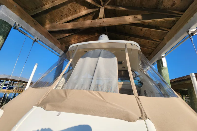 Let Me Liv! Yacht Photos Pics 2015 Formula 34 Performance Cruiser under wooden dock shelter, clear blue sky.