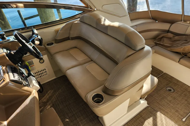 Let Me Liv! Yacht Photos Pics Interior of 2015 Formula 34 Performance Cruiser with beige seating and steering wheel.
