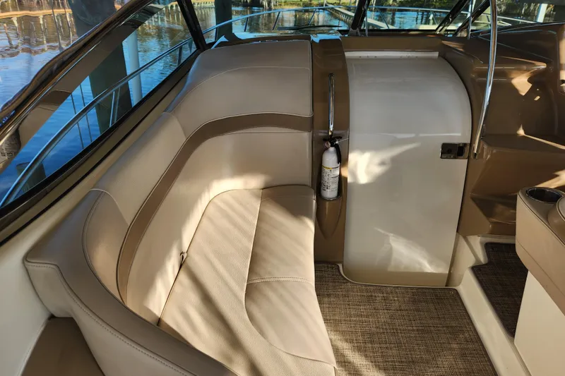 Let Me Liv! Yacht Photos Pics Interior of 2015 Formula 34 Performance Cruiser with beige seating and fire extinguisher.