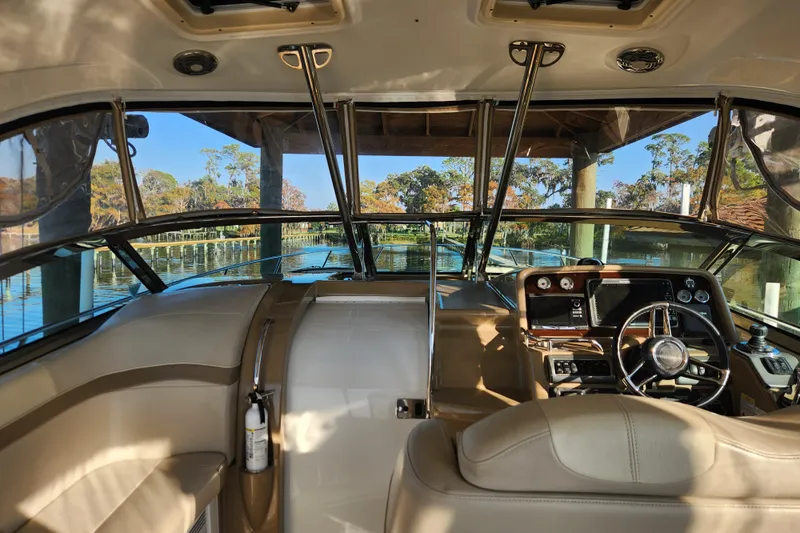 Let Me Liv! Yacht Photos Pics 2015 Formula 34 Performance Cruiser interior with steering wheel and dashboard, docked by scenic waterway.