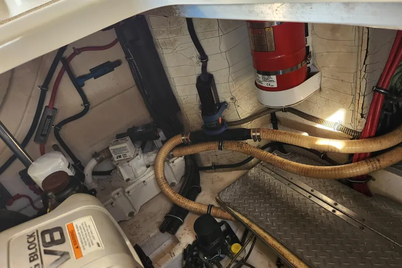 Let Me Liv! Yacht Photos Pics Engine compartment of a 2015 Formula 34 Performance Cruiser with visible hoses and fire extinguisher.