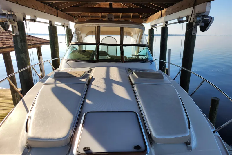 Let Me Liv! Yacht Photos Pics 2015 Formula 34 Performance Cruiser docked under a wooden canopy on calm water.