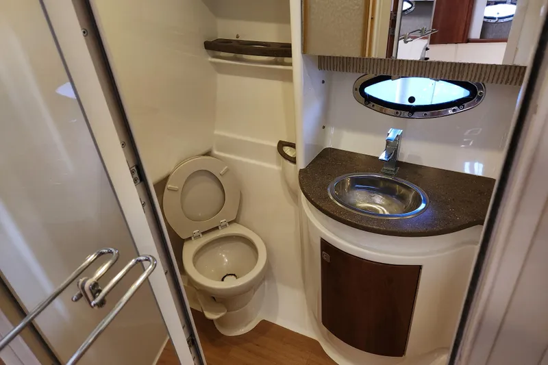 Let Me Liv! Yacht Photos Pics 2015 Formula 34 Performance Cruiser bathroom with toilet, sink, and porthole window.