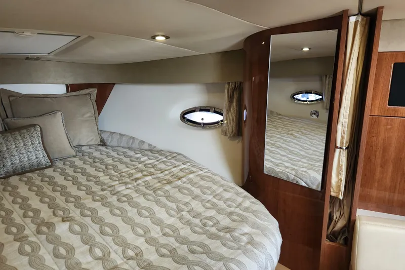 Let Me Liv! Yacht Photos Pics 2015 Formula 34 Performance Cruiser cabin with bed, mirror, and porthole window.
