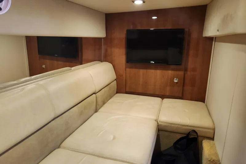 Let Me Liv! Yacht Photos Pics Interior of 2015 Formula 34 Performance Cruiser with beige seating and wall-mounted TV.