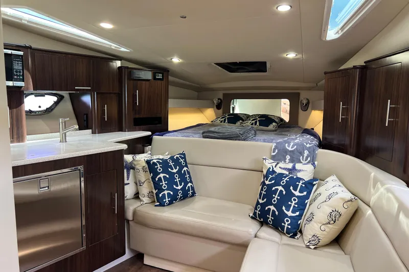  Yacht Photos Pics Luxurious interior of 2018 Regal 35 Sport Coupe with modern kitchen and cozy seating area.