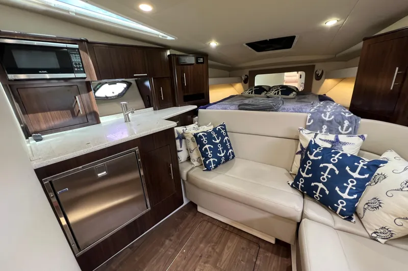  Yacht Photos Pics Luxurious interior of 2018 Regal 35 Sport Coupe with kitchen and cozy seating area.