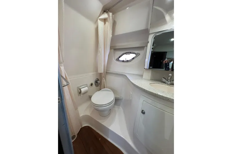  Yacht Photos Pics Bathroom interior of 2018 Regal 35 Sport Coupe yacht, featuring toilet and sink.