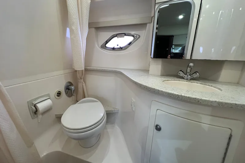  Yacht Photos Pics 2018 Regal 35 Sport Coupe bathroom with toilet, sink, and porthole window.