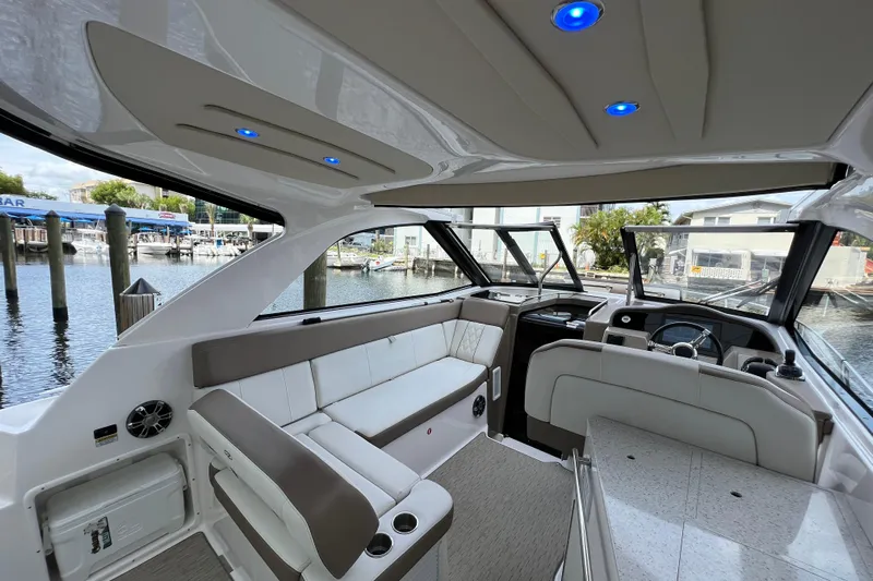  Yacht Photos Pics 2018 Regal 35 Sport Coupe interior with modern seating and dashboard, docked at marina.