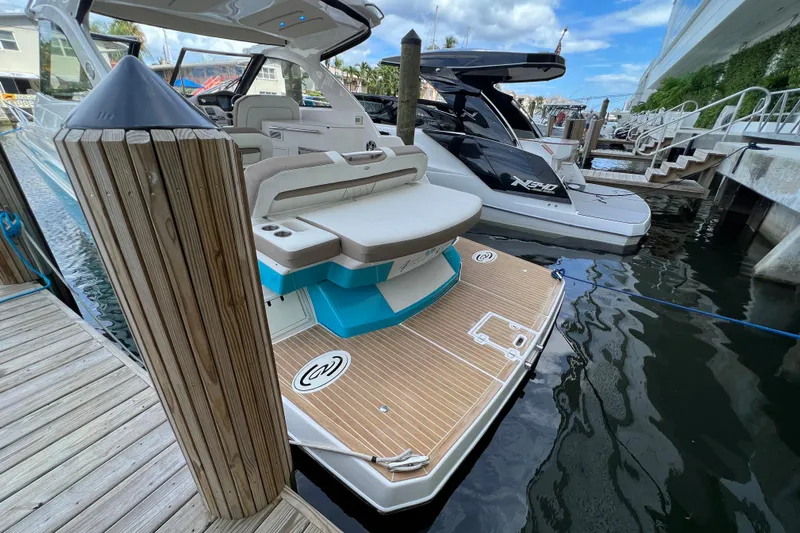 Yacht Photos Pics 2018 Regal 35 Sport Coupe docked, showcasing sleek design and spacious deck.