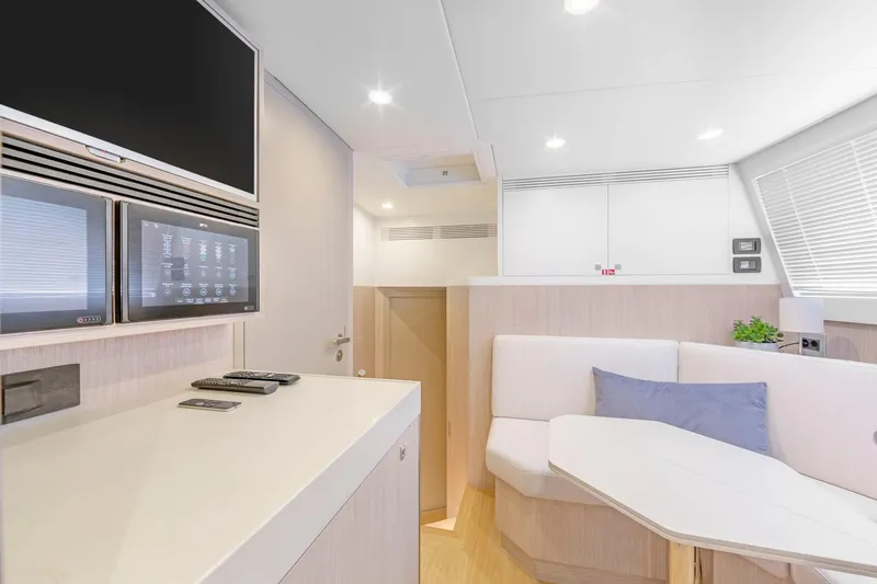 Helga Yacht Photos Pics Modern interior of 2021 Van der Valk RAISED PILOTHOUSE yacht with sleek design and cozy seating.