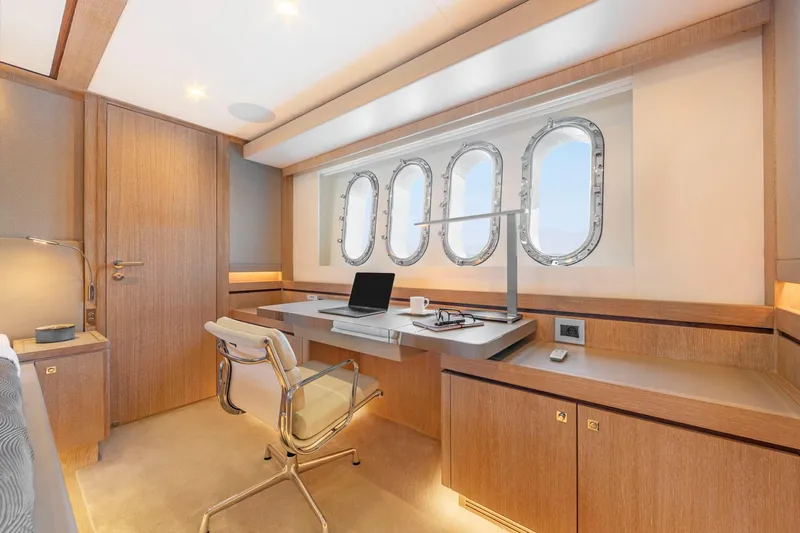 Helga Yacht Photos Pics Luxurious Van der Valk RAISED PILOTHOUSE 2021 yacht interior with desk and porthole windows.