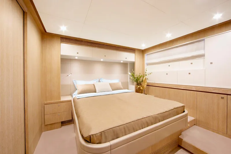Helga Yacht Photos Pics Luxurious bedroom interior in 2021 Van der Valk RAISED PILOTHOUSE yacht, featuring modern design.