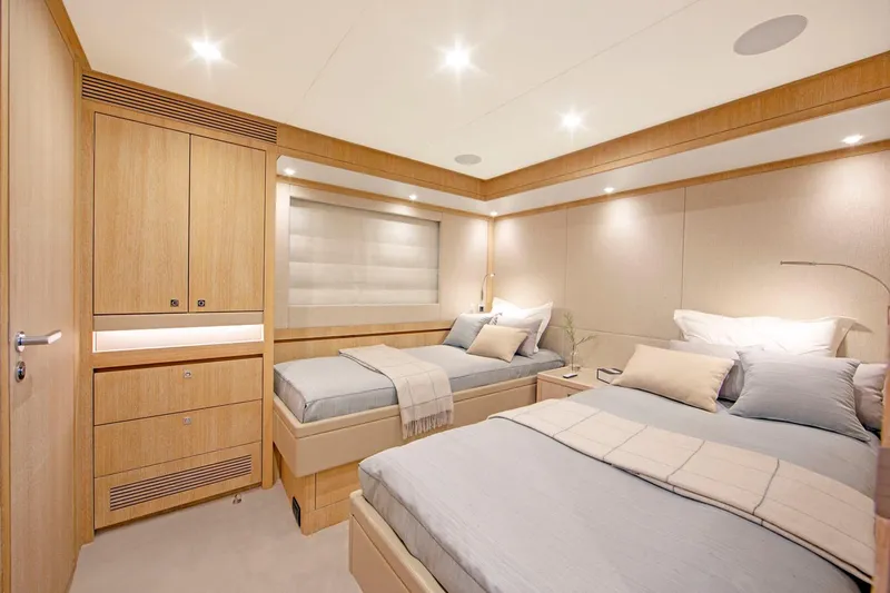 Helga Yacht Photos Pics Luxurious cabin interior of 2021 Van der Valk RAISED PILOTHOUSE yacht, featuring twin beds and modern decor.
