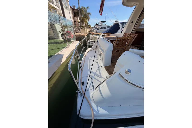 Le Reve Yacht Photos Pics 1999 Carver 530 Voyager Pilothouse yacht docked, featuring a spacious deck and wooden chairs.